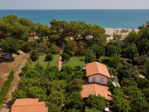 an aerial view of a house with the ocean in the background at Baraka House in Cıralı