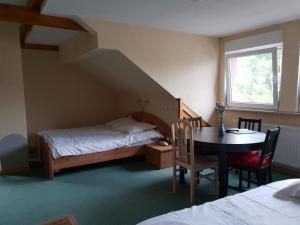 1 dormitorio con 1 cama, 1 mesa, 1 cama, 1 mesa y sillas en Hotel Du Donon, en Grandfontaine