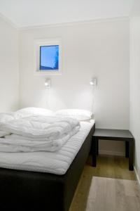 A bed or beds in a room at Hafjell Alpinlandsby Pluss