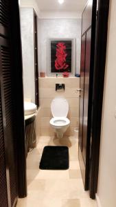 a bathroom with a white toilet and a sink at Appartement Casablanca in Casablanca