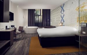 a hotel room with a large bed and a large window at Inntel Hotels Amsterdam Centre in Amsterdam