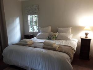 a large white bed in a room with a window at Apartment Chapel Road in Hillcrest