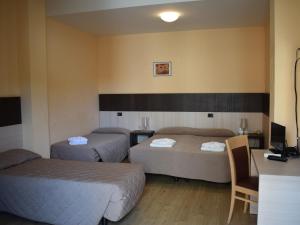 A bed or beds in a room at Hotel Bamby