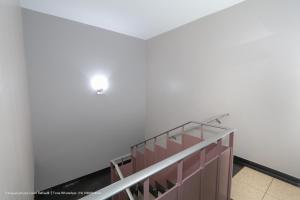 a staircase in a building with a light on the ceiling at Hotel Princeton in Piracicaba