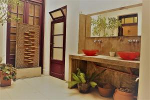 a bathroom with two red sinks and a mirror at Meridiano Hostel Boutique in Buenos Aires