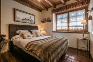 a bedroom with a large bed with two pillows at Solei by FeelFree Rentals in Garós