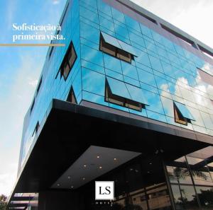 a building with a reflection of the sky in the windows at LS Hotel in João Pessoa