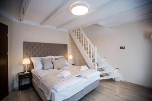 a bedroom with a large bed and a staircase at Villa Baltica in Świnoujście