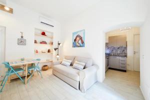 a living room with a white couch and a table at Burò Bed & Relax in Parma