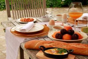 a wooden table with plates of food on it at B&B Villa Anna, Venlo in Venlo