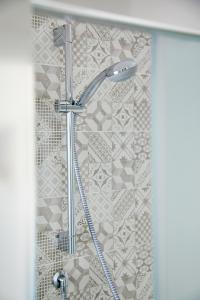 a shower with a shower head in a bathroom at Burò Bed & Relax in Parma