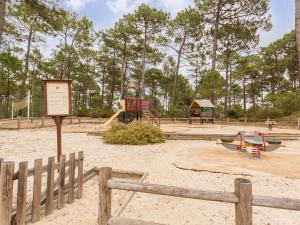 a park with a playground with a slide at Residence Les Grands Pins - maeva Home in Carcans