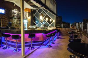 a bar with purple lighting at a rooftop bar at Hotel Alex Caracas in Caracas