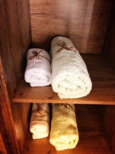 a wooden shelf with three rolls of towels at ”Modern Apartment” Old City Constanta in Constanţa +29 photos