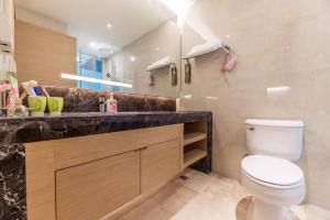 a bathroom with a toilet and a sink and a mirror at Chengdu Hi - Tech·Global Center Locals Apartment 00139620 in Chengdu +16 photos