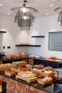 a bakery with a bunch of different types of bread at Hotel Verlaine in Cannes