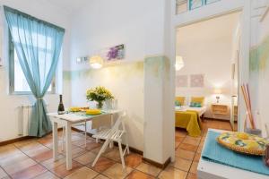 a small living room with a table and a bed at Rome As You Feel - Monti Apartment in Rome