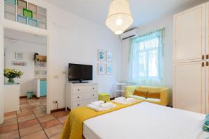 a bedroom with a bed and a tv in it at Rome As You Feel - Monti Apartment in Rome