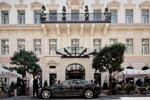 a car that is parked in front of a building at Aria Hotel Budapest by Library Hotel Collection in Budapest