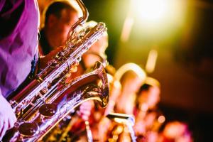 a person playing a saxophone in a band at Andrew Jackson Hotel French Quarter in New Orleans
