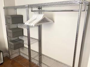 a wire shelving unit in a closet with baskets at Nice Central Art Deco Flat 45 m² in Nice