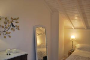 ポルトにあるCasa Braancamp - Beautiful & Calmの鏡付きのベッドルーム(ベッド1台、ランプ付)