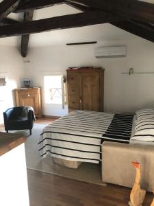 a bedroom with a large bed and a chair at Alla vigna in Bassano del Grappa
