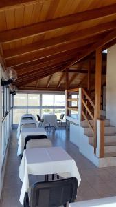 a row of tables in a room with wooden ceilings at Apart Hotel Santa Lucia in Mar del Plata