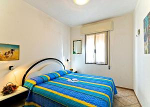 ビビオーネにあるGliciniのベッドルーム1室(青と黄色の毛布付きのベッド1台付)