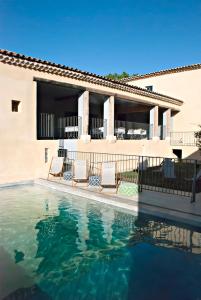 a swimming pool in front of a house at Chartreuse de Mougeres - Pézenas in Caux