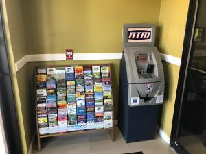a atm machine in a store next to a wall at Paradise Inn & Suites in Baton Rouge