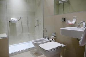 a bathroom with a toilet and a shower and a sink at Amérian Villa del Dique in Villa del Dique