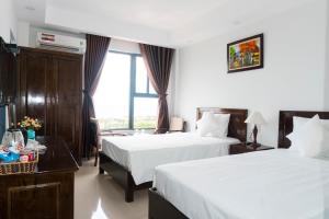Postel nebo postele na pokoji v ubytování Aries Hotel
