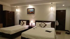 Postel nebo postele na pokoji v ubytování Aries Hotel