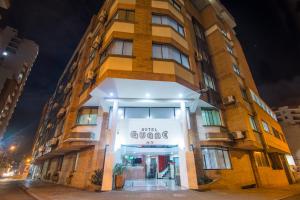 a tall building with a sign in front of it at Hotel Guane in Bucaramanga