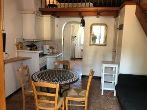 une cuisine et une salle à manger avec une table et des chaises dans l'établissement Maison de pêcheur à Porquerolles, à Porquerolles