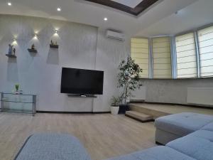 a living room with a flat screen tv on the wall at Apartment on Dragomirova in Kyiv
