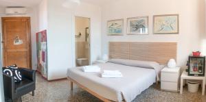 a small bedroom with a bed and a chair at Alloggio Casa Loredan in Venice