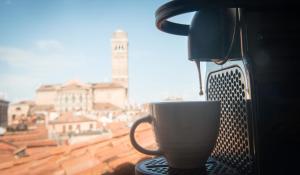 a coffee cup sitting on a table next to a window at Alloggio Casa Loredan in Venice