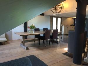 a dining room with a table and chairs at In de Schuur in Ochten