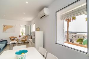 a living room with a table and chairs and a window at The Sailor House in Villajoyosa