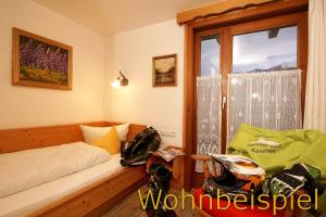 1 dormitorio con cama y ventana en Panorama Hotel Kaserer en Fischen