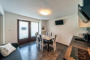 a kitchen and dining room with a table and chairs at Apartament Glamour in Biały Dunajec