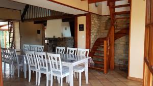 a dining room with a table and white chairs at La Cantraigne in Audembert +23 photos