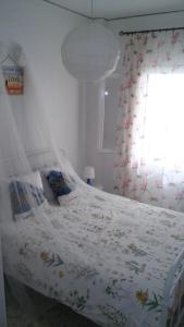 a bedroom with a bed with a curtain and a window at Αnna's Home!!!Holidays in beautiful Athens in Athens