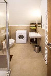 ein Badezimmer mit einer Waschmaschine und einem Waschbecken in der Unterkunft Ubytovanie DOBRÁ LIPA in Bratislava