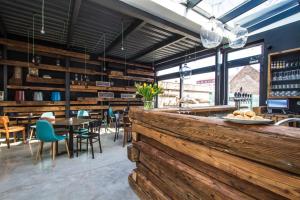 a restaurant with a wooden bar with tables and chairs at Ubytovanie DOBRÁ LIPA in Bratislava