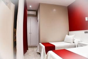 Postel nebo postele na pokoji v ubytování Hostal Playa Candor
