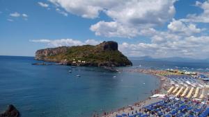 a beach with many umbrellas and people on it at Villaggio Turistico La Mantinera - Residence in Praia a Mare