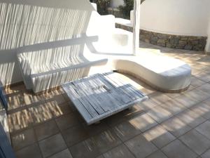 a bench sitting on top of a patio at GKMykonos in Ano Mera